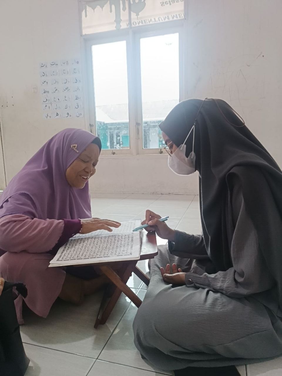 Ustadzah Mira membenarkan bacaan lansia binaan Almarhamah
