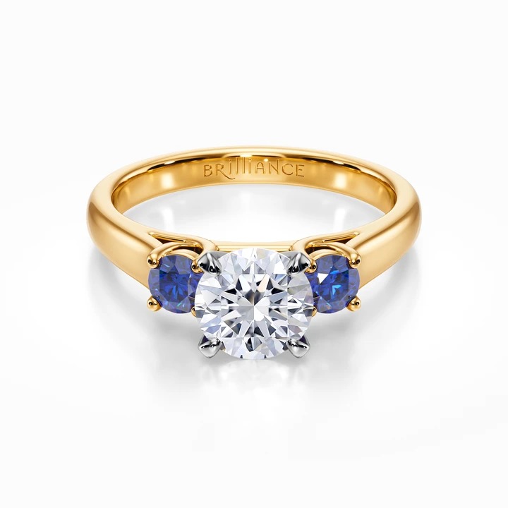 Source : https://www.brilliance.com/cdn-cgi/image/f%3Dwebp%2Cwidth%3D720%2Cheight%3D720%2Cquality%3D90/sites/default/files/engagement-rings/round-sapphire-gemstone-ring-yellow-gold/1yellowrenderingwhitegoldsapphiresidestoneengagementringsettingtop.jpeg